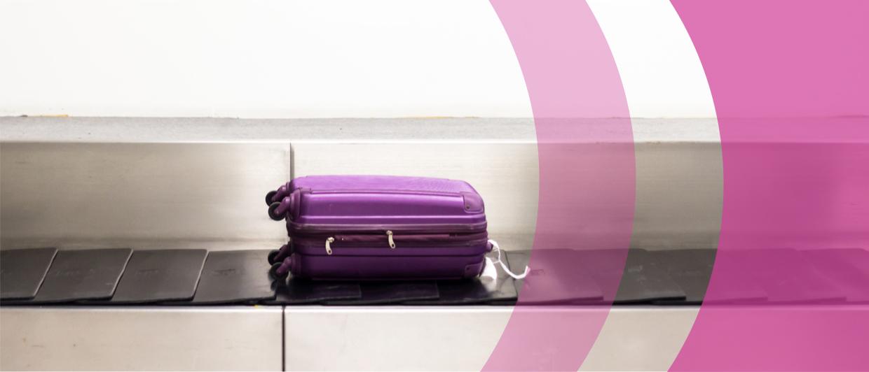 Image of purple suitcase on a conveyor belt