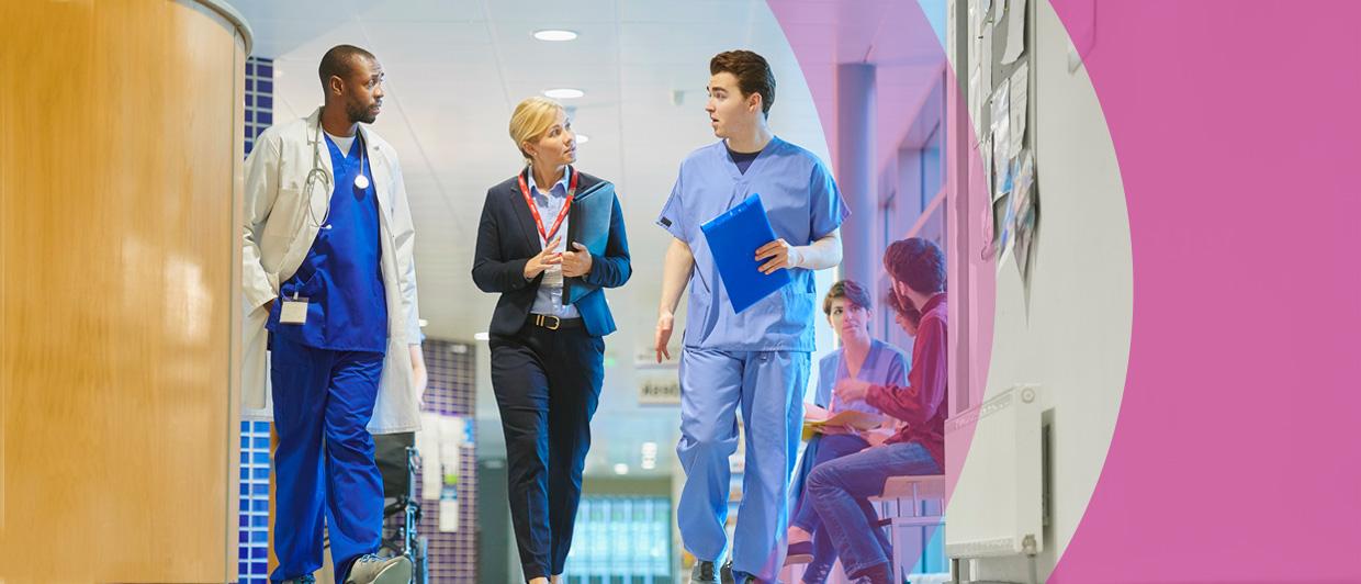 image of doctors walking through hospital corridor